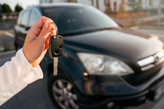 hand-holding-car-keys-selective-focus-woman-buyi-2022-11-19-01-24-17-utc